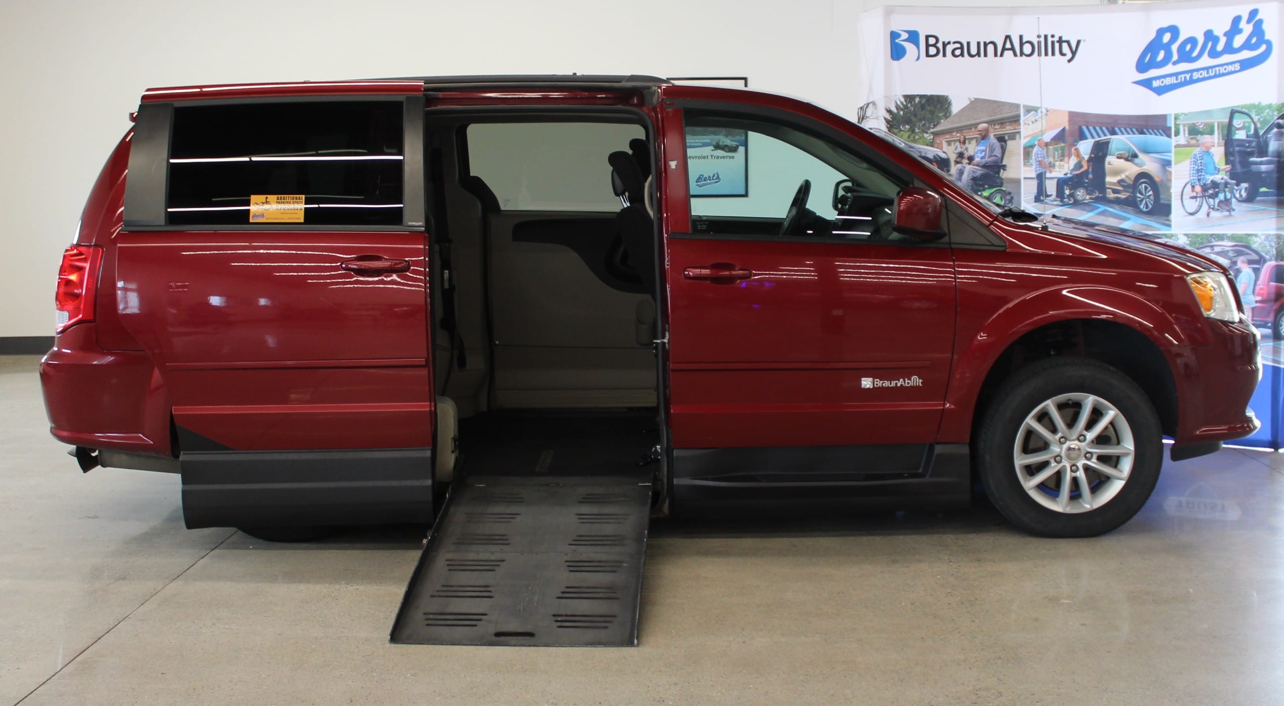 Passenger side with the ramp deployed for sale used wheelchair accessible van.